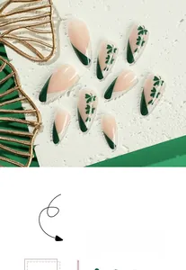 Close-up of almond-shaped St. Patrick's Day press-on nails with green clover designs