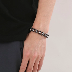 Detail of silver and black industrial bicycle chain bracelet worn on male wrist