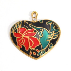 Detailed macro view of 18k gold heart pendant with black enamel and floral hummingbird