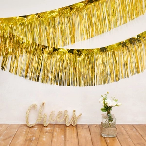 Shiny gold fringe tinsel curtain backdrop for birthday party decorations and events