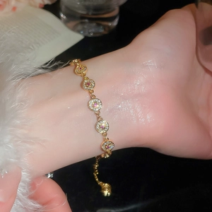 Detailed view of an elegant 18K gold plated bracelet with round zircons on a wrist