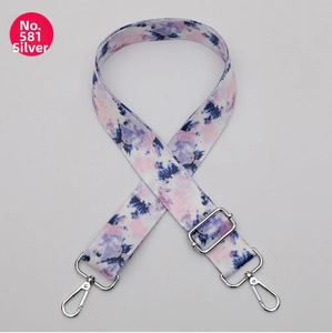 Detail of adjustable tie-dye shoulder strap with silver metal hooks for handbags