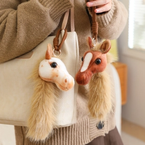Plush cartoon pony head keychain charm for bags with long faux fur mane and gold hardware