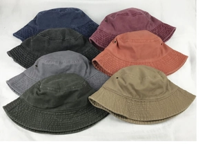 Close-up of assorted short-brim washed cotton bucket hats with metal eyelets detail