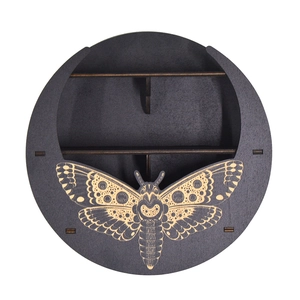 Detail of round wooden Boho wall shelf featuring intricate moth carving and two-tier storage