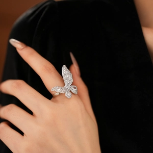 Detailed macro shot of an adjustable silver butterfly ring with sparkling cubic zirconia