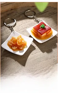 Miniature Braised Abalone and Dongpo Pork food charms with white plates and keyrings