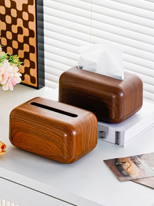 Close-up of minimalist walnut wood grain tissue box on a clean white desk with decor