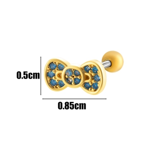 Macro shot of a tiny gold bow stud earring with blue zircons and measurement detail