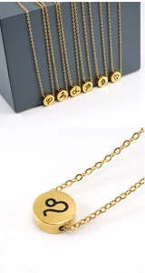 Macro shot of gold stainless steel Leo constellation pendant necklace with fine chain