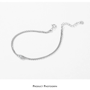 Close-up of double-layered S925 silver bracelet featuring a bezel-set round zircon stone