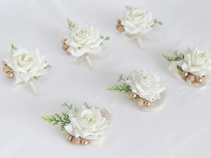 Detail of 6pcs white rose boutonnieres with gold berries and beige striped ribbon