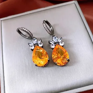 Vintage orange zircon waterdrop earrings with gunmetal finish on a luxury jewelry box