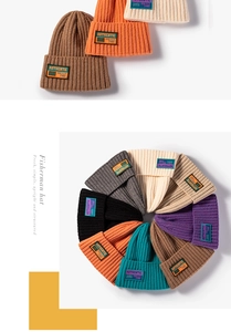 Close-up of ribbed knit beanies featuring vintage textile labels in various colors