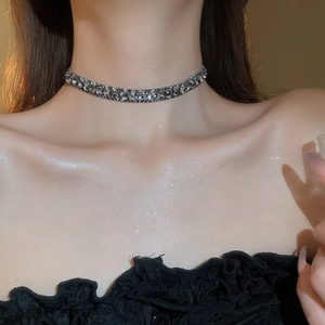 Close-up of sparkling full-diamond silver choker necklace worn on model's neckline