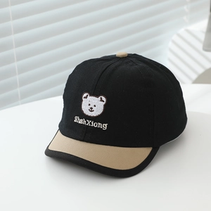 Detail of baby baseball cap with bear embroidery and contrast short brim in cotton