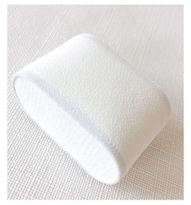 Detailed view of a soft white velvet watch pillow for jewelry display and presentation