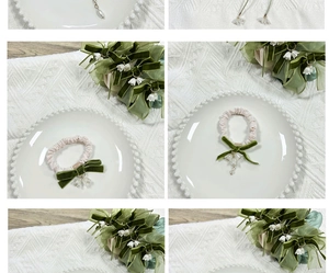 Close-up of pink silk hair tie with green velvet bow and lily of the valley charm