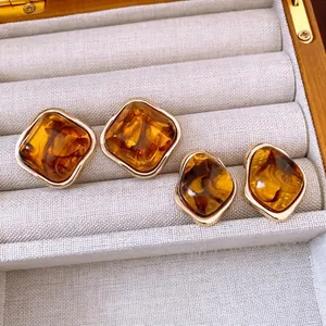 Retro geometric resin earrings set with gold wave texture frame in amber finish