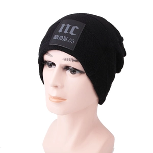 Close-up of black knit beanie with leather patch and thermal fleece lining detail