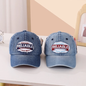 Detailed texture of vintage washed denim baseball caps with embroidery patches for kids
