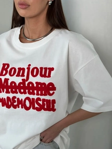 Close-up of Bonjour Madame flocked lettering on high-quality white cotton T-shirt