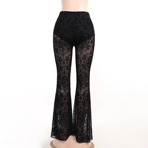 Close-up detail of sheer black floral lace texture on high-waisted flared trousers