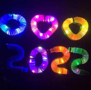 Glow in the dark pop tubes toys shaped as 2022 digits with vibrant LED lights