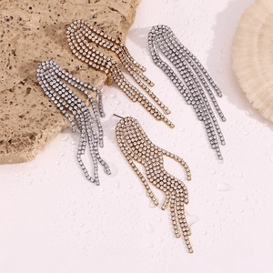 Detail of layered tassel earrings with 18K gold plating and micro-set zircon crystals