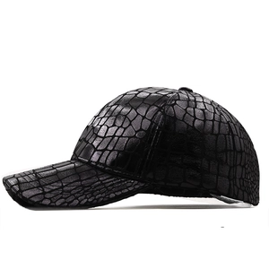 Detail view of the black crocodile pattern embossed leather texture on baseball cap