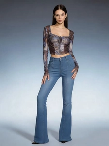 Detail of light blue flared jeans with distinctive vertical front seams and slim fit design