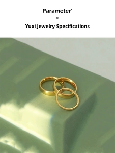 Close-up of minimalist 18K gold-plated titanium steel ring set on a modern surface