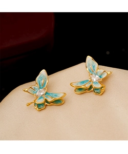 Close-up of enamel butterfly earrings with teal gradient and sparkling center zircon