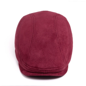 Detailed view of dark burgundy suede flat cap with vertical decorative stitching