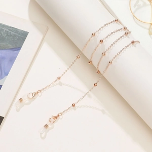 Close-up of rose gold beaded glasses chain with white silicone loops and lobster clasp