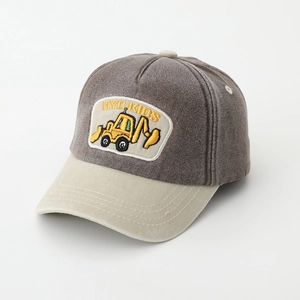 Detail of excavator embroidery patch and contrast stitching on kids baseball cap