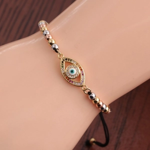 Gold-plated Evil Eye charm bracelet with colorful beads shown on a model wrist