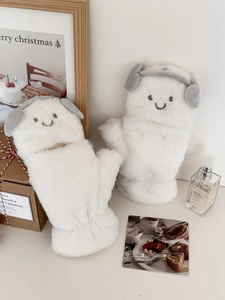 Close-up of plush white mittens with cute smiley face and fuzzy headphone decor