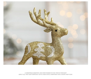 Close-up of golden glitter reindeer Christmas decoration with white tree pattern and bokeh lights