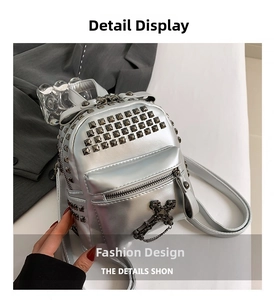 Detailed view of silver mini backpack featuring punk square studs and cross charm chain