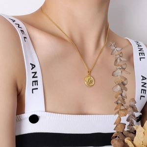 Elegant 18K gold plated titanium steel necklace featuring a textured wing pendant
