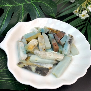 Macro detail of natural amazonite long bar beads for DIY jewelry in a shell dish