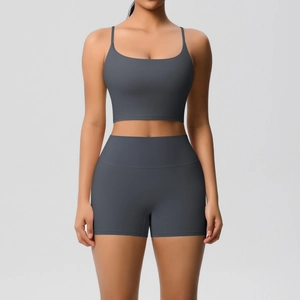Close-up of high-elasticity dark grey yoga set with thin straps and high-waist shorts