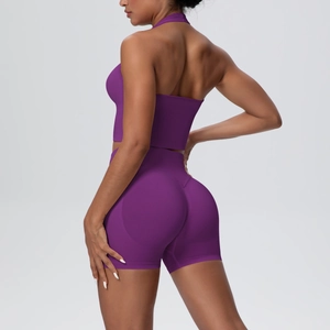 Side view of purple seamless yoga set with halter crop top and high-waisted lift shorts
