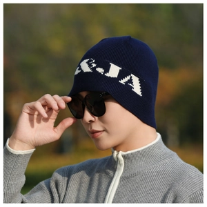 Detailed close-up of navy blue knitted beanie featuring white A-J-A jacquard pattern