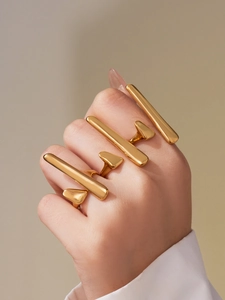 Detail of 18k gold plated stainless steel geometric rings set on a model's hand