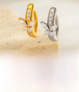 Detailed close-up of titanium butterfly belly rings with sparkling zircon inlay set
