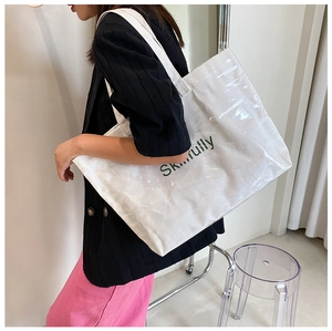 Side view of white canvas tote bag with transparent PVC layer and Skillfully text print
