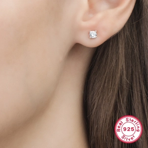 Macro detail of sterling silver earring featuring a sparkling cubic zirconia stud on ear