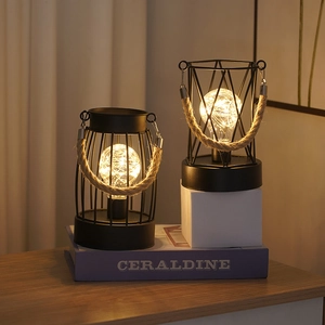 Industrial iron cage lanterns with warm LED copper wire lights and hemp rope handles